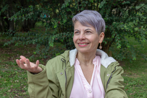 istock Middle aged woman posing in a public park 2089179439