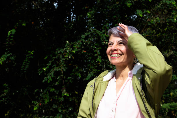 istock Middle aged woman posing in a public park 2089180504