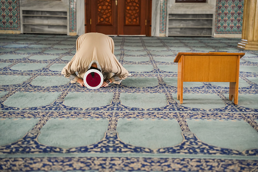 Imam praying in the mosque prostrates