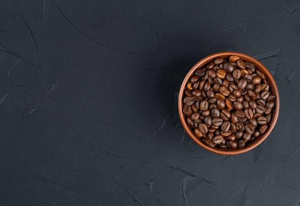 istock Roasting coffee beans in a bowl on a dark background 2089191999