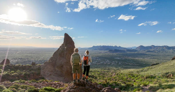 istock Hikers pause on top of boulder 2089225953