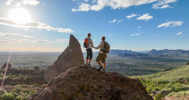 istock Hikers pause on top of boulder 2089225954