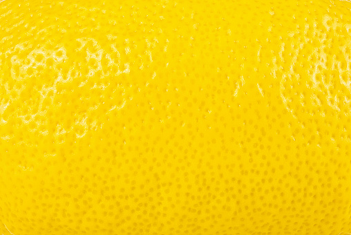 Ripe lemon peel texture, as background. Fresh citrus fruit.