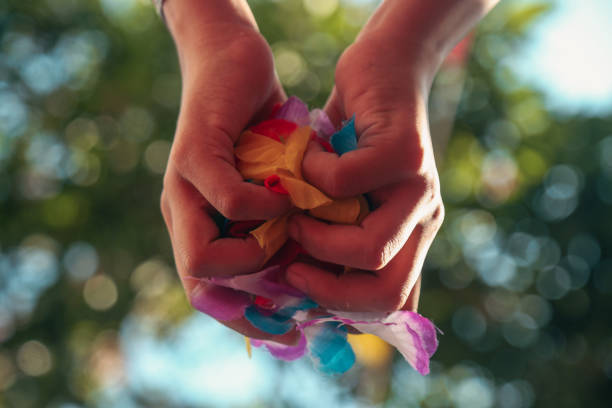 istock hands holding fake flowers 2089244092