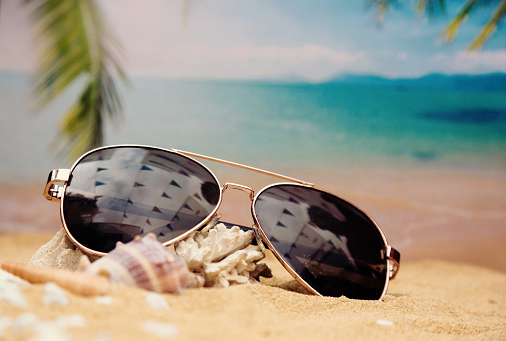 Close-up of sunglasses on the beach
