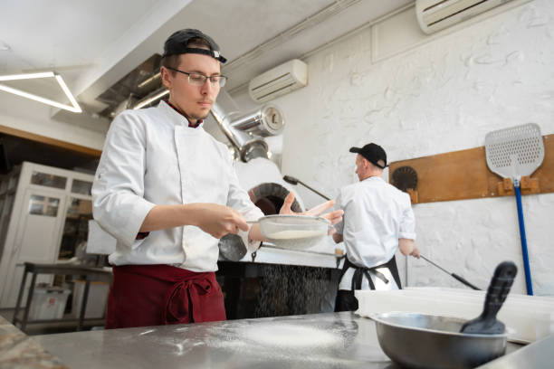 istock The cook pours flour on the table for making pizza dough close-up. 2089246654