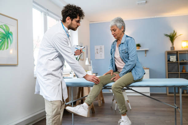 istock Orthopedist examining senior female patient's knee 2089258540