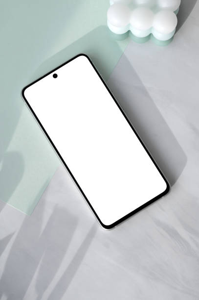 istock Empty smartphone screen mockup with copy space, pastel mint green paper, on neutral white marble table background with natural sunlight shadows, minimal aesthetic spring business branding template 2089272011