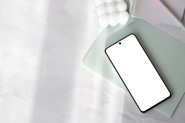 istock Smartphone with blank screen mockup, light pastel green paper stationery on white neutral marble table background with natural sunlight shadows , aesthetic template for social media 2089273059