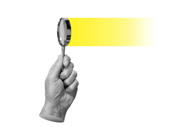 Magnifying glass in hand, searching, researching, focusing on yellow light. Insight, solution, find and study concept