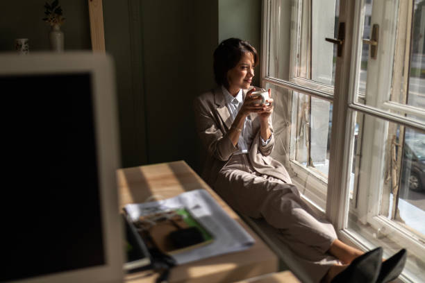 istock Businesswoman Refreshing with Coffee on Ledge 2089280316