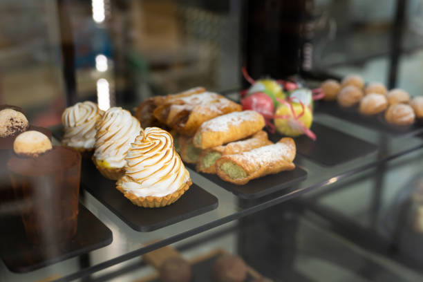 istock A showcase with sweets in a cafe. Cupcakes and colorful macaroons on the cake stand. 2089304875