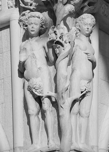 Venice, VE, Italy - February 13, 2024: Biblic figure of Adam and Eve in the corner of Ancient Ducal Palace