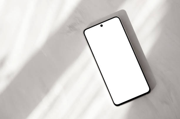 istock Mobile phone with blank screen mockup on neutral beige marble desk background with natural sunlight shadows, aesthetic minimal business branding template 2089342397
