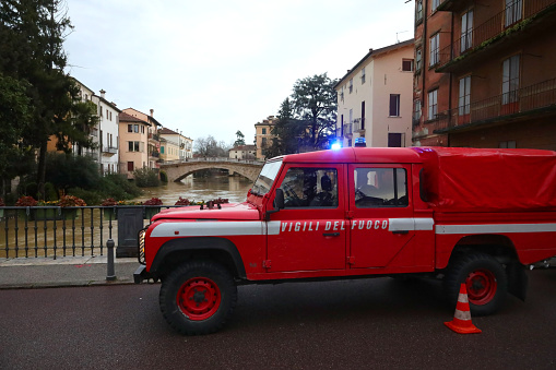 Vicenza, VI, Italy - January 28, 2024: Italian van of italian firfighter called VIGILI DEL FUOCO while raining during flood in the city
