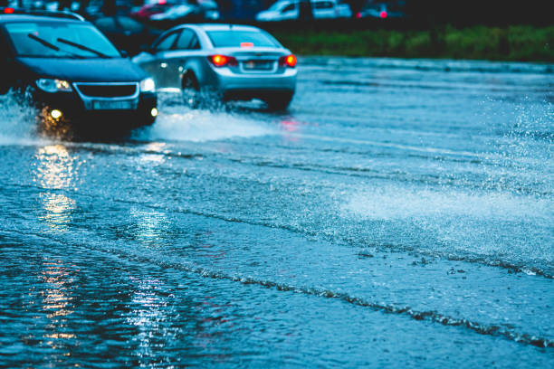istock Car driving through puddle. Water splashes. Bad weather. Torrential rain 2089377768