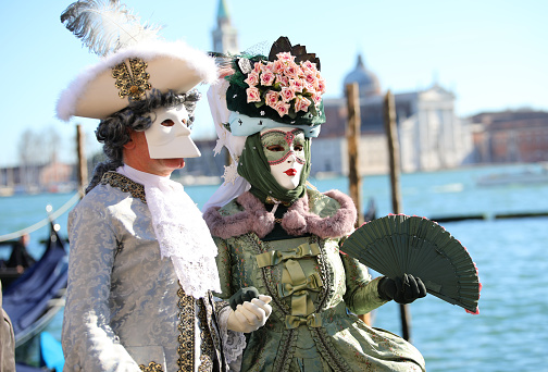 Venice, Italy - February 16, 2020: Beautiful colorful masks at traditional Venice Carnival in Venice, Italy