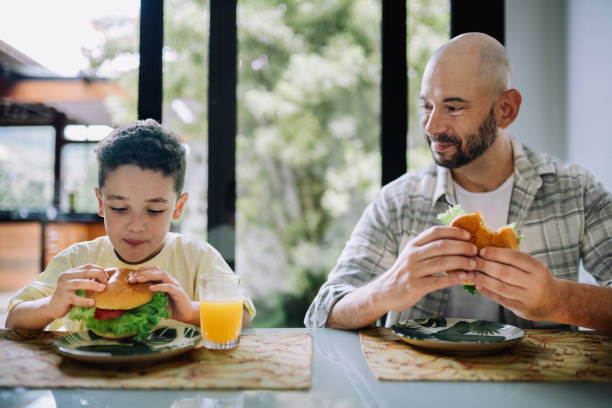 istock Dad and his little son eating hamburger together 2089389852