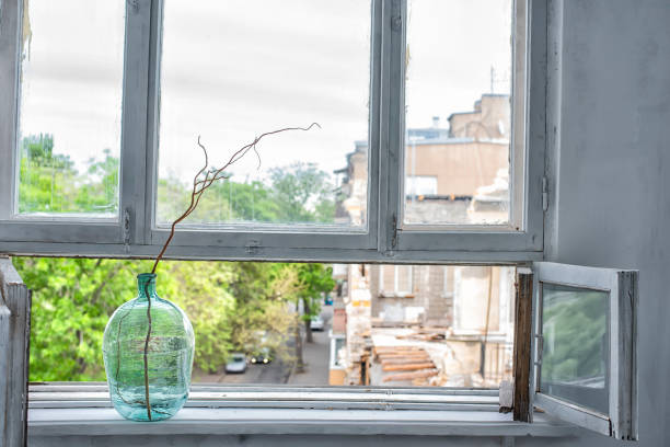 Sunlight reflecting on a polished wooden window sill in an old building with leaded glass