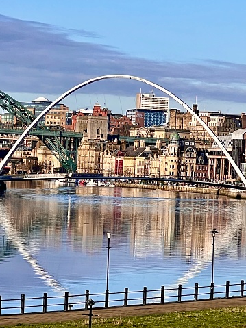 Panoramic view of the Newcastle and Gateshead Quayside and River Tyne with the Gateshead Millennium Bridge and part of the Tyne Bridge in view