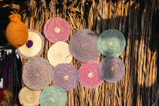Variety of weaved mats from dried palm leaves, traditional Emirati handicraft at the market Variety of weaved mats from dried palm leaves, traditional Emirati handicraft at the market in Abu Dhabi. High quality photo. palm fiber stock pictures, royalty-free photos & images