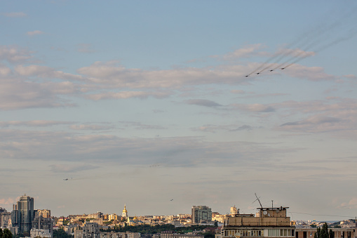 Aerial summer cityscape with flying military airplanes during parade dedicated to Independence Day of Ukraine.