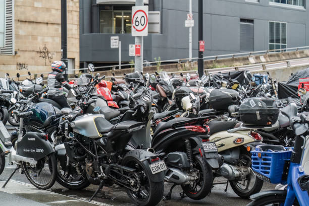 A Dense Parking Area Filled With Various Motorcycles And Scooters, With Street Signs In The Background Sydney, NSW, Australia, February 21st 2024. A dense parking area filled with various motorcycles and scooters, with street signs in the background. speed limit sign australia stock pictures, royalty-free photos & images