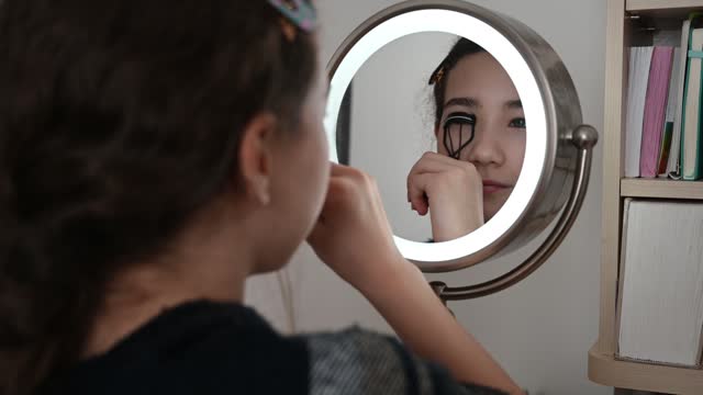 Teenager girl curving eyelashes