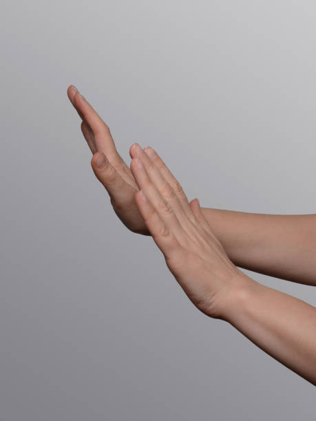 istock Hands showing a refuse, defense or stop hand gesture sign on a light gray background. 2089525616