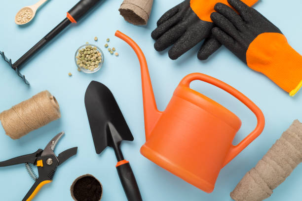 istock Orange gardening tools on color background, top view 2089526670