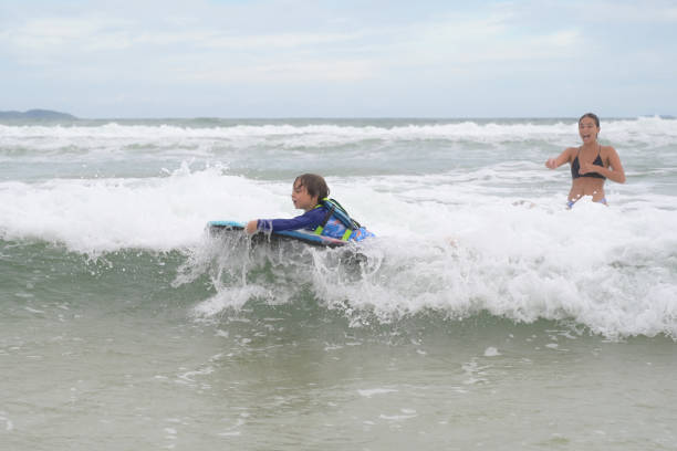 istock brothers in the sea playing with the waves 2089533905