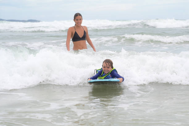 istock brothers in the sea playing with waves 2089534443