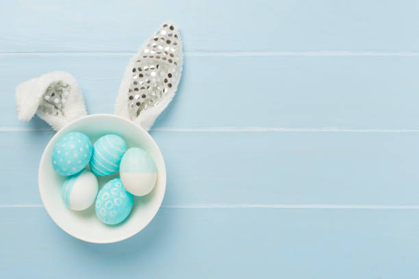 istock Blue easter eggs with bunny on wooden background, top view 2089546329