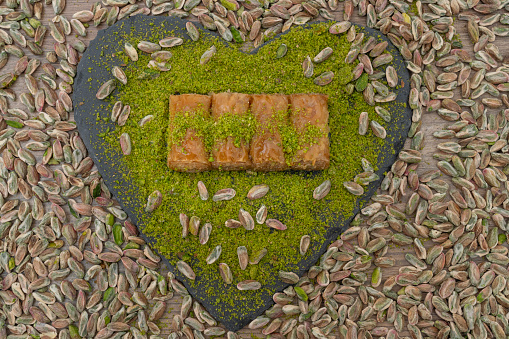 Turkish organic pistachio and pistachio baklava on slate.