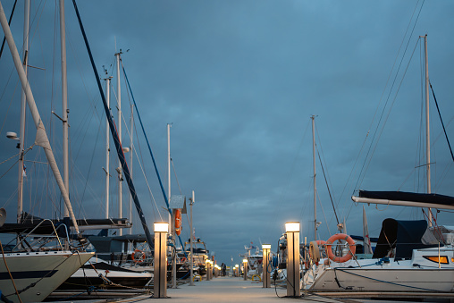 port pier with luxury yachts and ships and cloudy evening sky. High quality picture