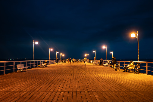 night molo pier with lantern yellow light at Polish village Jastarnia. High quality photo