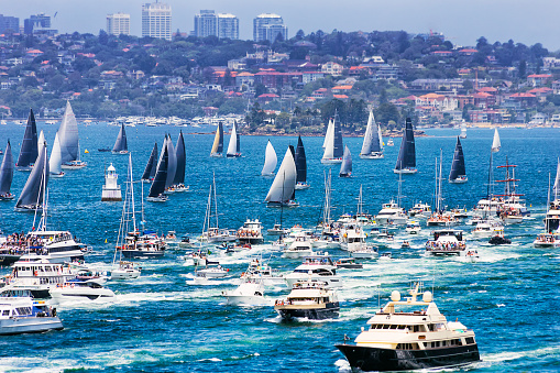 Start line of Sydney Hobart yacht race in Sydney Habour on boxing day - flotilla of sail yachts and spectator boats.