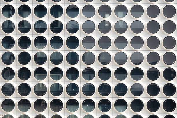 A lot of windows on a skyscraper building. Urban textures and backgrounds. Modern architecture and design. Building details.