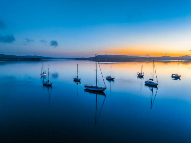 istock Aerial sunrise waterscape with boats, reflections and low cloud 2089601231