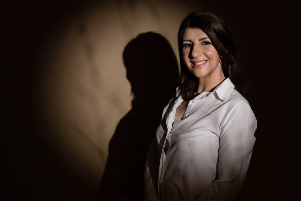 istock Middle aged brunette woman under spot light 2089604371