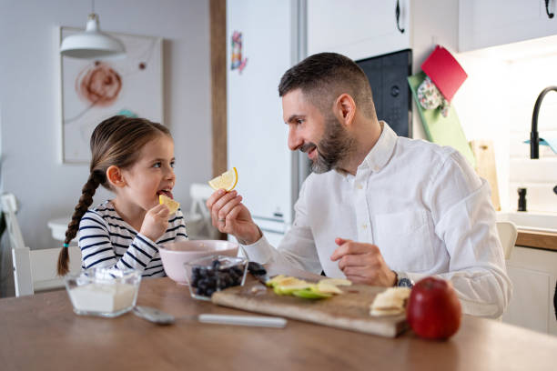 istock Father and daughter having slice of lemon for an breakfast 2089629936