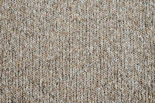 Beige knitted fabric background.