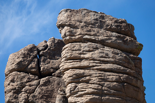 The rock formations at Chiricahua National Monument were carved by ice and water from layers of volcanic ash deposited by an eruption millions of years ago.