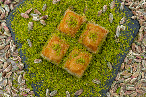 Turkish organic pistachio and pistachio baklava on slate.