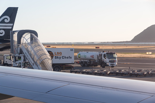 Wellington, New Zealand - February 21, 2024: Air New Zealand on the tarmac at Wellington Interntational Airport refuelling and loading passenger meals prior to flying.