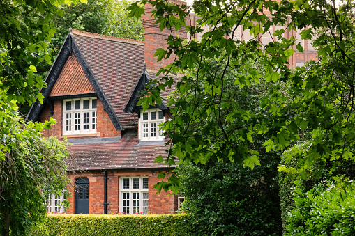 Dublin, Ireland - August 4, 2023: Lush vegetation and a beautiful historic house at Saint Stephen's Green, one of Ireland's oldest and famous public parks