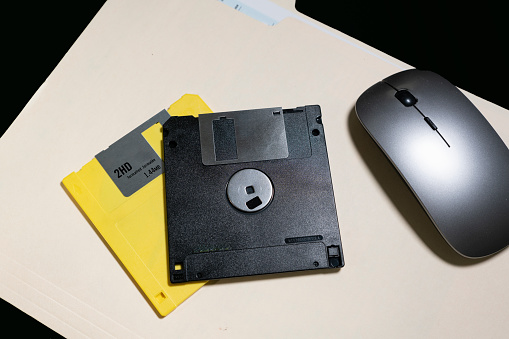 Old 3 and a half inch floppy disks on a manila folder.