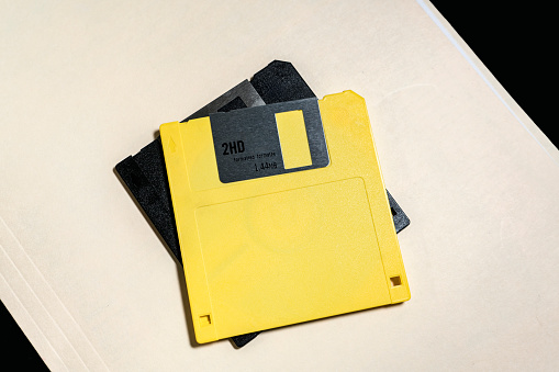 Old 3 and a half inch floppy disks on a manila folder.