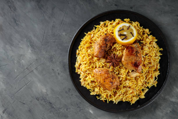 istock Chicken Biryani with Spices on Black Plate, Indian Cuisine Concept, Top View, Copy Space 2089750989