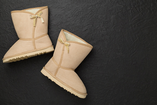 Suede boots on concrete background,top view